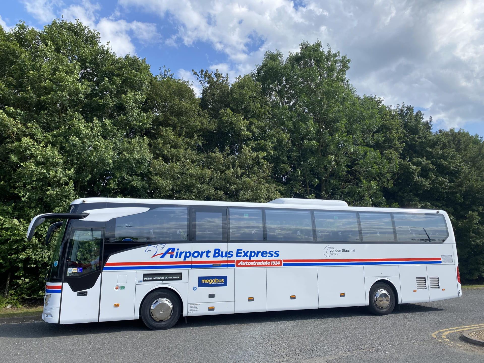 Airport Bus Express coach serving London Stansted Airport, fitted with GPS-triggered passenger announcements