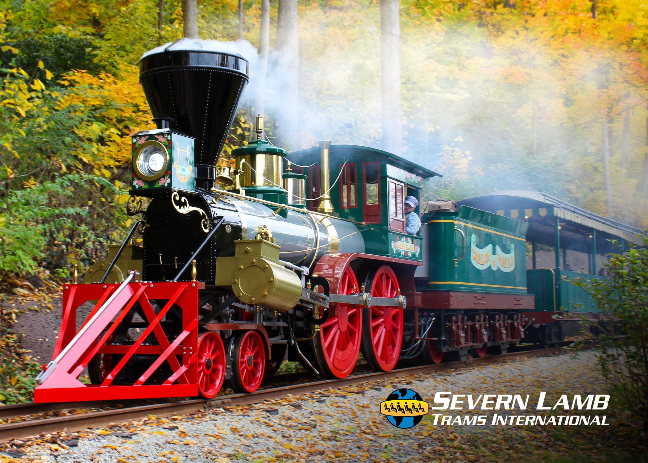 Severn Lamb heritage steam-style tourist train passing through autumn forest, fitted with EasyGuide multi-language commentary